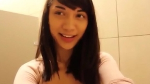 Asian teenage Mei wanks in public toilet